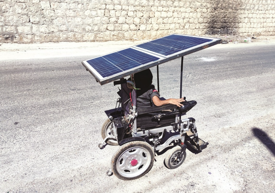 a picture showing a man on wheelchair powered by solar panels